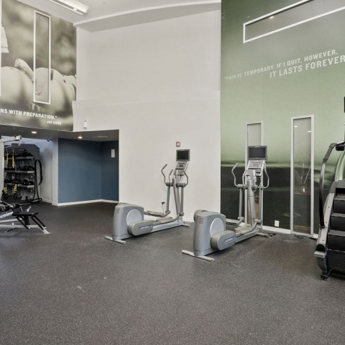 Large fitness center with cardio and weight lifting equipment.