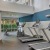large fitness center with treadmill, tall open ceilings, bright with large windows
